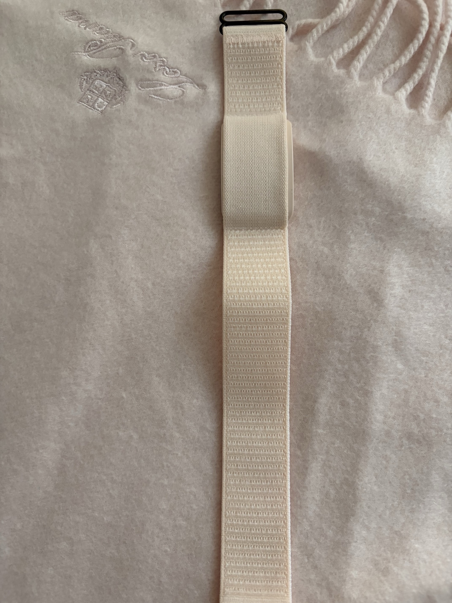 Cream Soul Vibe Band photographed flat on textured fabric